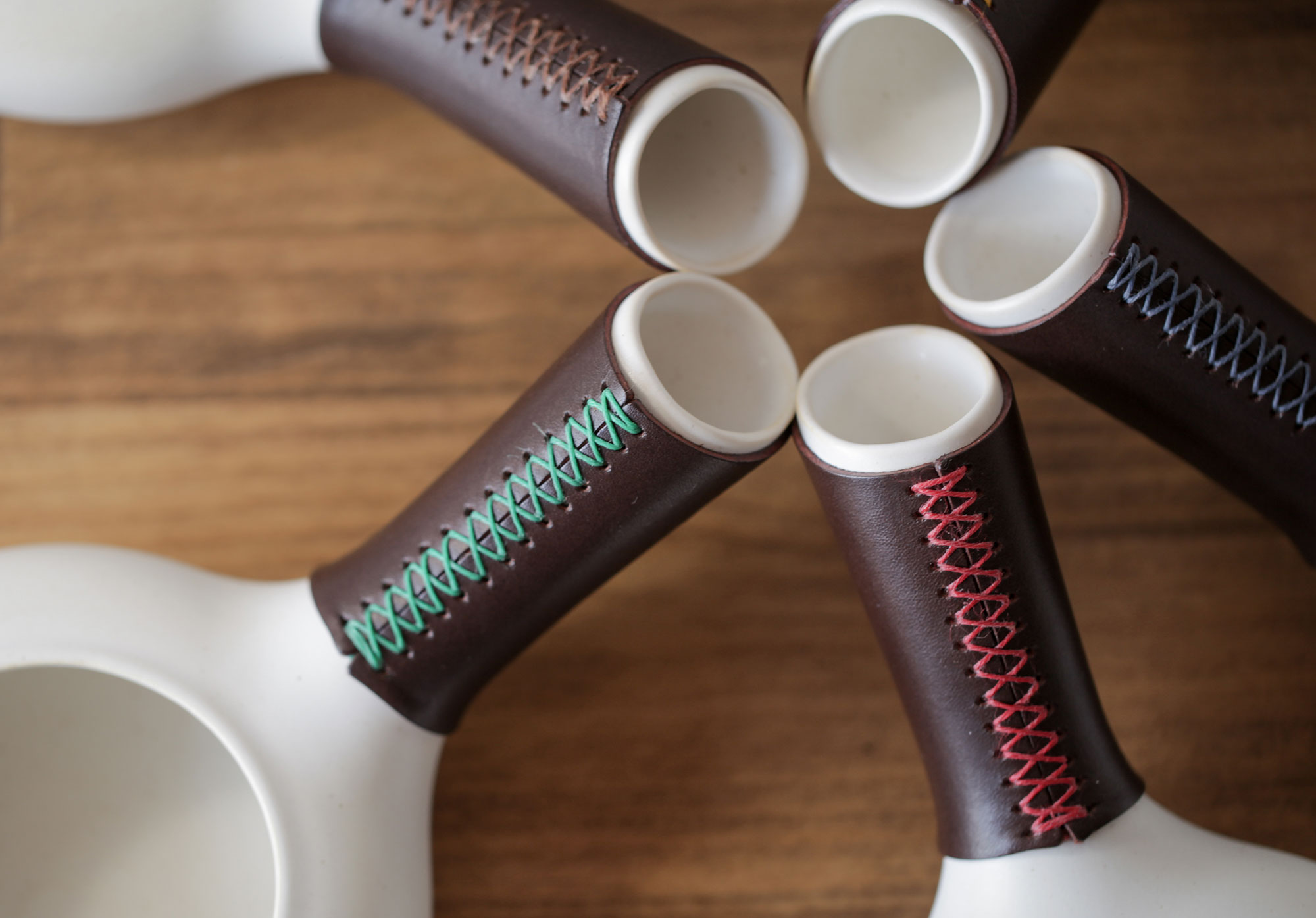 Hand-stitched leather covers in five thread colors
